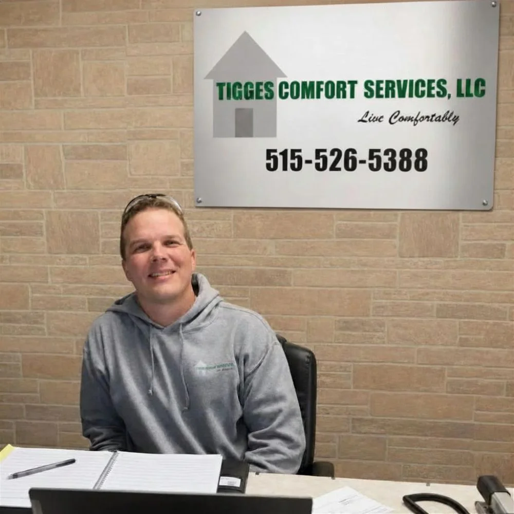 Jason Tigges, owner of Tigges Comfort Services at his desk in his shop in Redfield, Iowa.